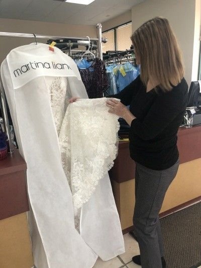 Bride Inspecting the gown after cleaning